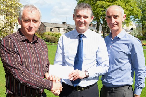 Roddy McAteer (centre) being presented with a Travel Voucher in recognition of his 20 years service within Murdock Builders Merchants from Ciaran Murdock (Left) and Kevin Murdock (right), Directors of The Murdock Group. Photograph: Peter Clarke